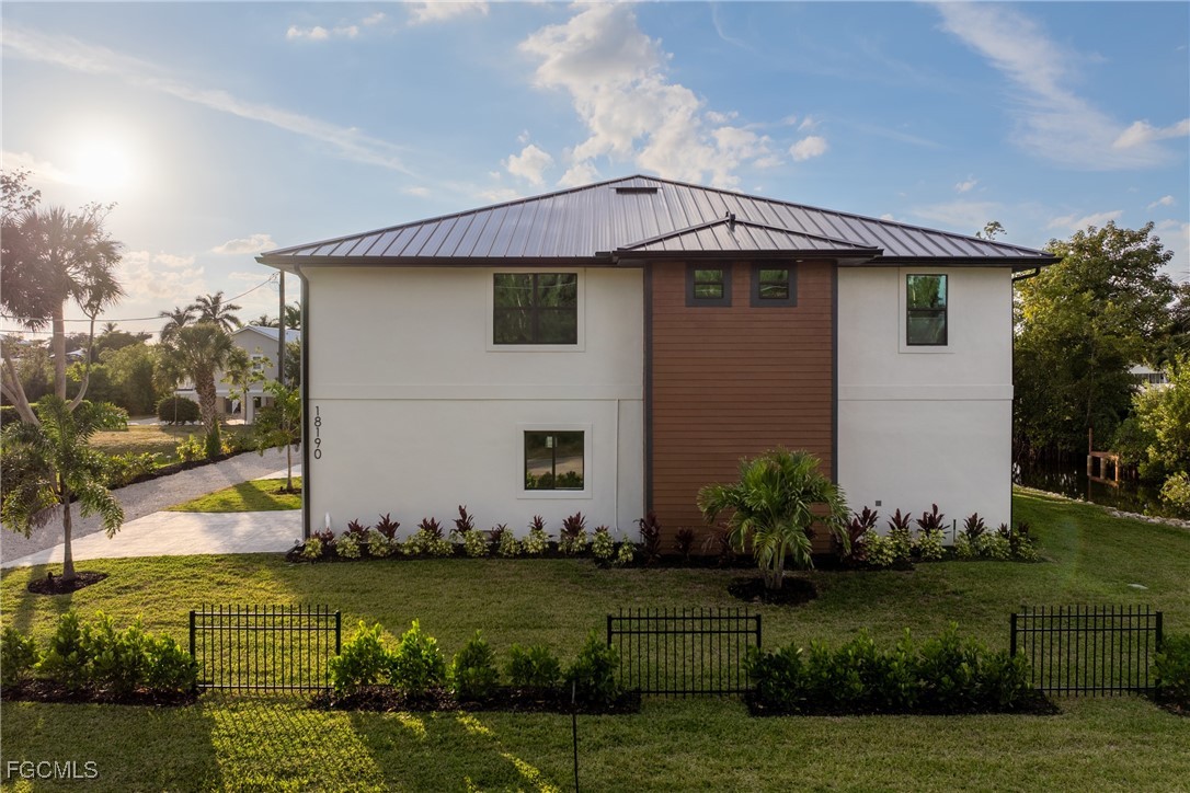 18190 Pioneer Road Fort Myers, FL 33908 - Photo 2 of 45 a front view of a house with a garden