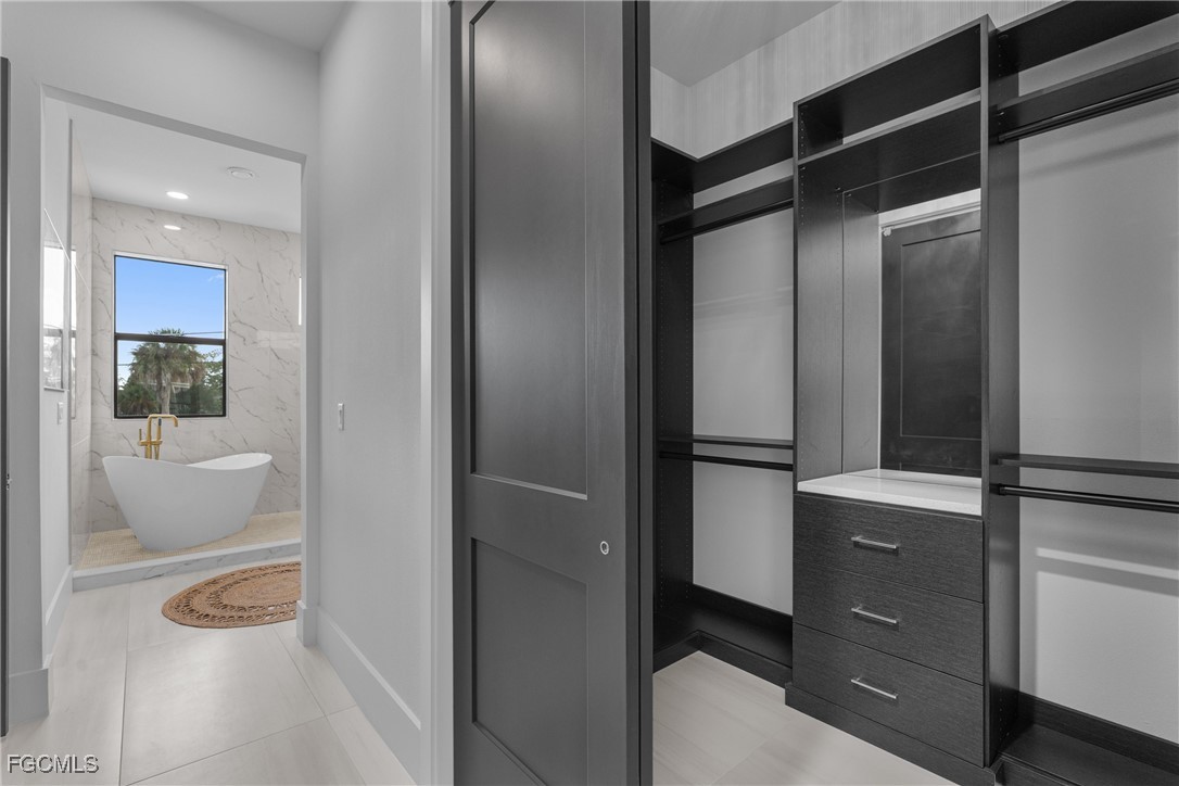 18190 Pioneer Road Fort Myers, FL 33908 - Photo 22 of 45 a kitchen with a refrigerator and cabinets