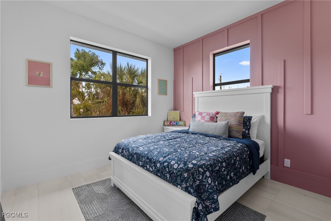 18190 Pioneer Road Fort Myers, FL 33908 - Photo 26 of 45 a bedroom with a bed and a painting on the wall