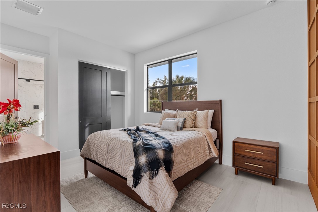 18190 Pioneer Road Fort Myers, FL 33908 - Photo 28 of 45 a bedroom with a bed dresser and a window