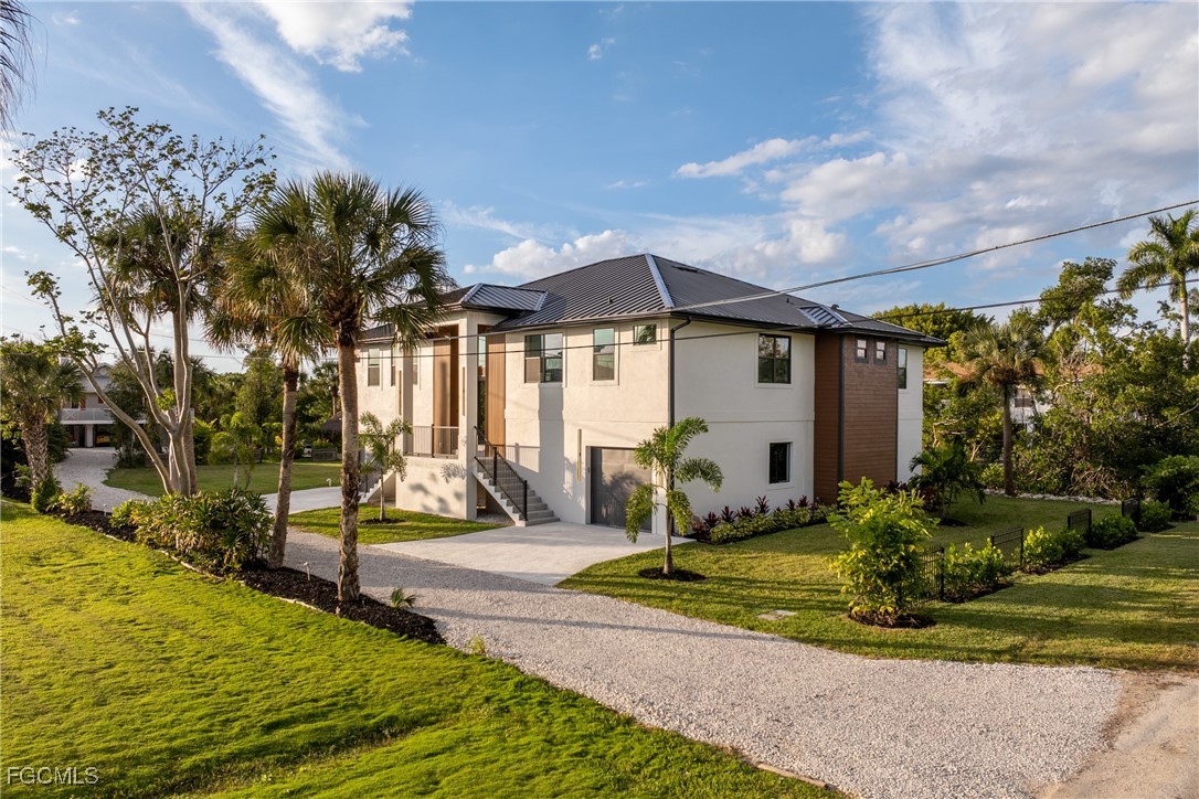 18190 Pioneer Road Fort Myers, FL 33908 - Photo 3 of 45 a front view of a house with a yard