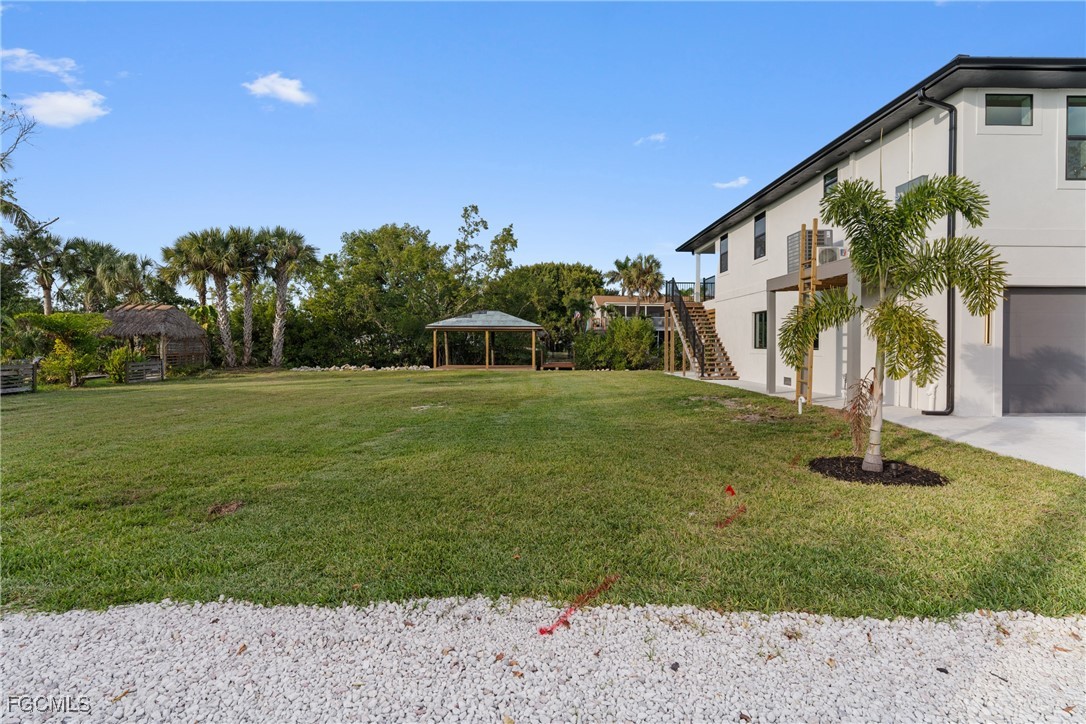 18190 Pioneer Road Fort Myers, FL 33908 - Photo 4 of 45 a view of a house with a yard