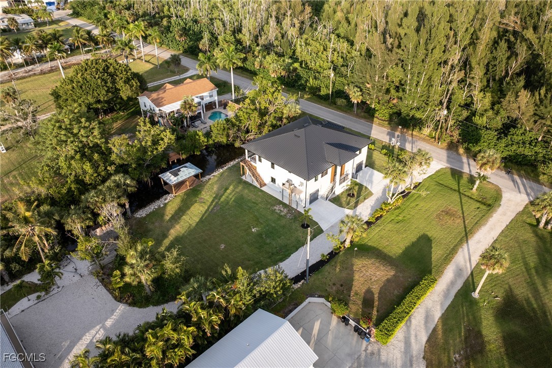 18190 Pioneer Road Fort Myers, FL 33908 - Photo 43 of 45 an aerial view of a house with a yard and large trees