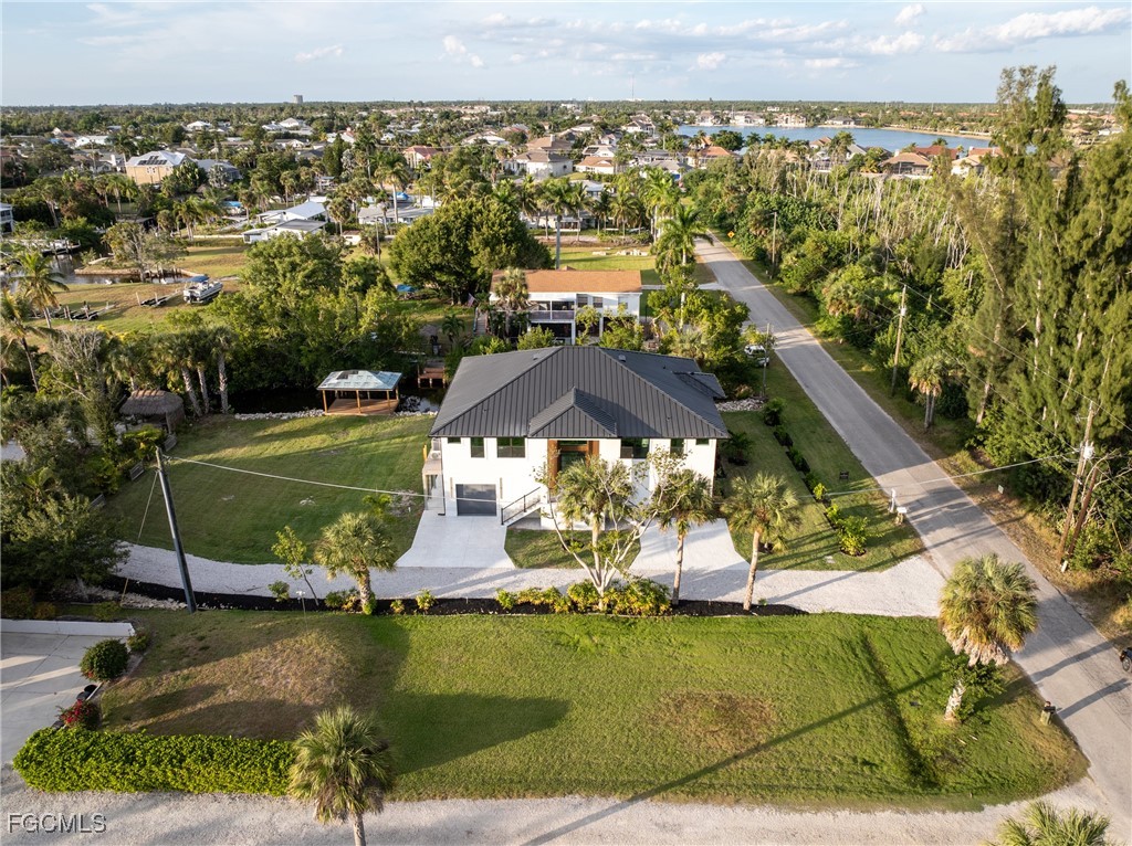18190 Pioneer Road Fort Myers, FL 33908 - Photo 44 of 45 an aerial view of a house with a garden and lake view