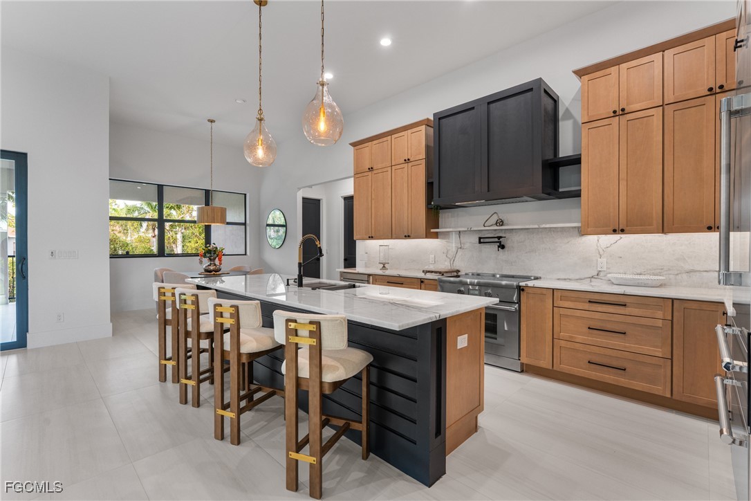 18190 Pioneer Road Fort Myers, FL 33908 - Photo 7 of 45 a kitchen with kitchen island granite countertop wooden cabinets and white appliances