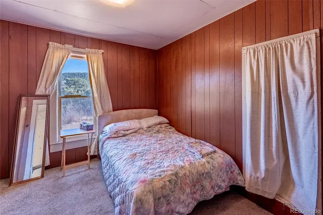 a bed sitting in a bedroom next to a window