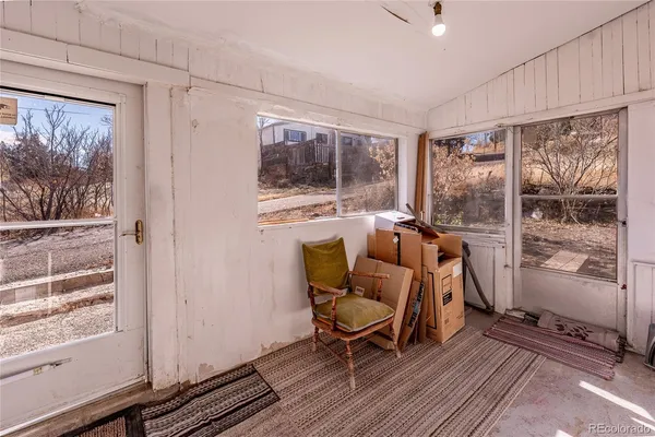 a workspace with wooden floor and a window