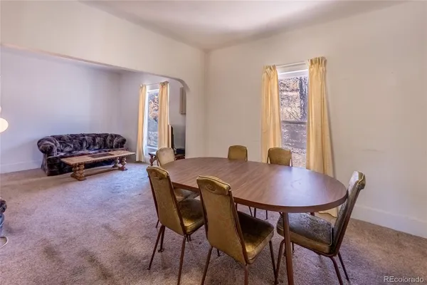 a view of a dining room with furniture and a window