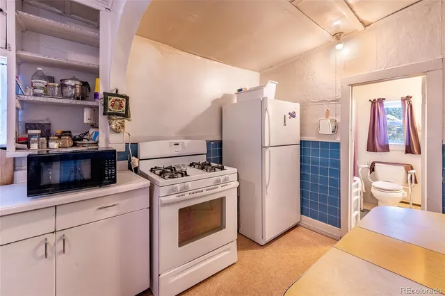 a kitchen with stainless steel appliances granite countertop a stove a refrigerator and a cabinets