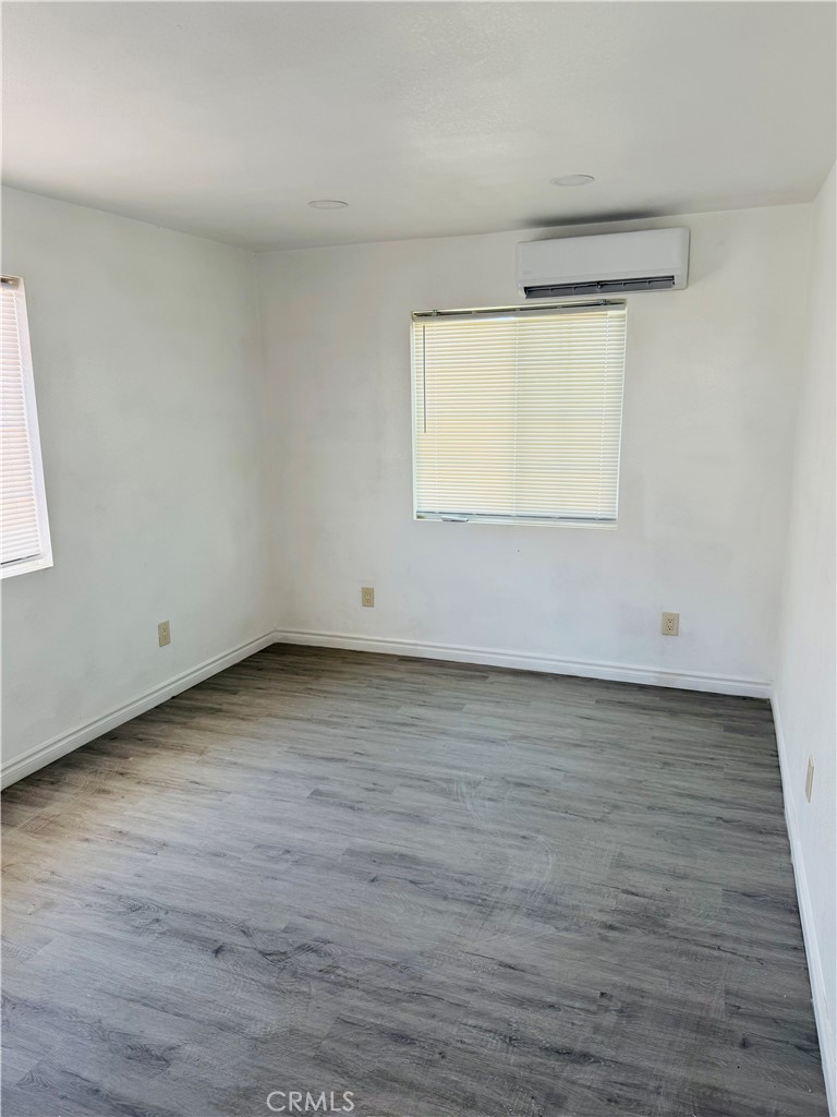 5827 Old Woman Springs Road Johnson Valley, CA 92285 - Photo 4 of 13 a view of an empty room with wooden floor and a window