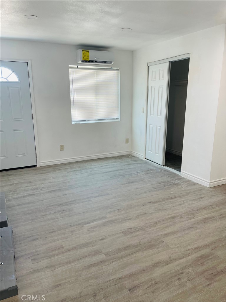 5827 Old Woman Springs Road Johnson Valley, CA 92285 - Photo 6 of 13 a view of an empty room with wooden floor and a window