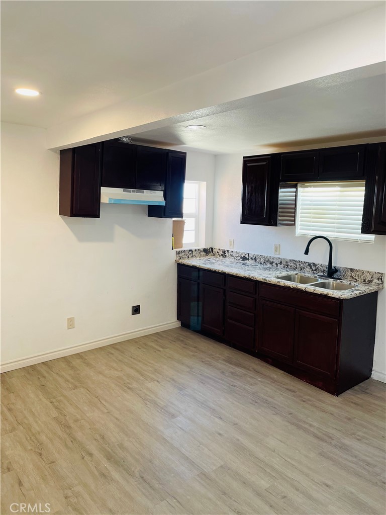 5827 Old Woman Springs Road Johnson Valley, CA 92285 - Photo 8 of 13 a kitchen with stainless steel appliances granite countertop a sink and a stove