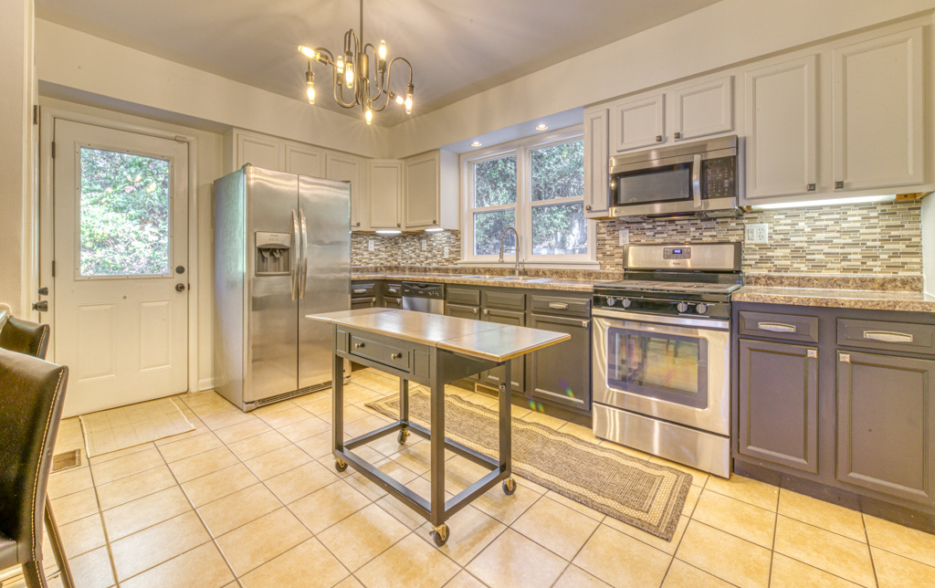 307 North Lake Street Gary, IN 46403 - Photo 2 of 38 a kitchen with stainless steel appliances granite countertop a stove top oven a sink dishwasher and a refrigerator
