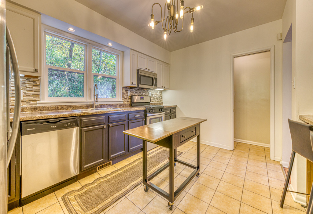 307 North Lake Street Gary, IN 46403 - Photo 11 of 38 a kitchen with stainless steel appliances granite countertop a stove a sink dishwasher and a refrigerator