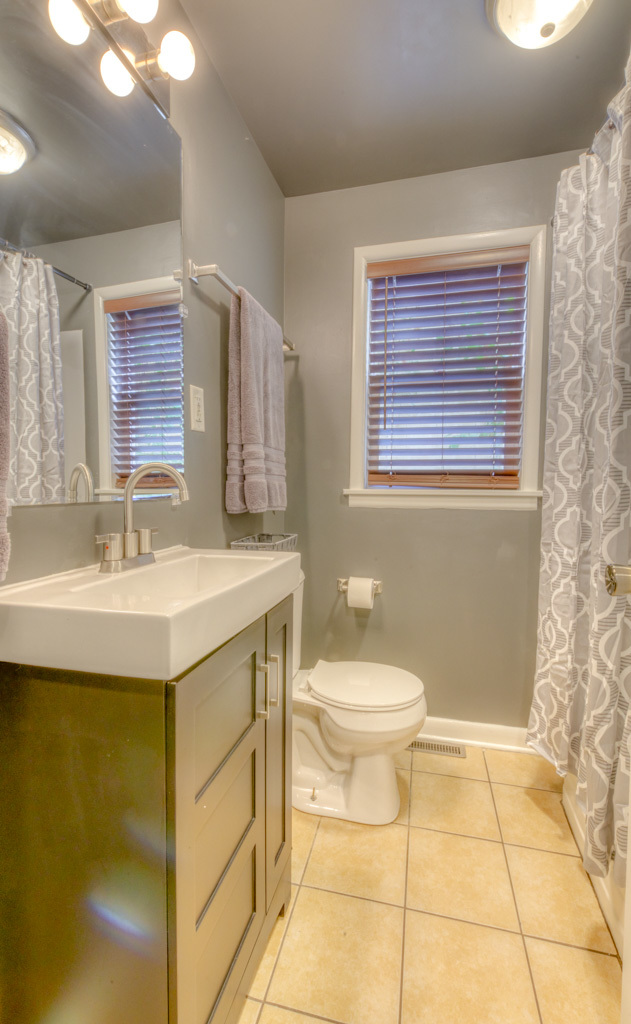 307 North Lake Street Gary, IN 46403 - Photo 13 of 38 a bathroom with a sink a toilet and mirror