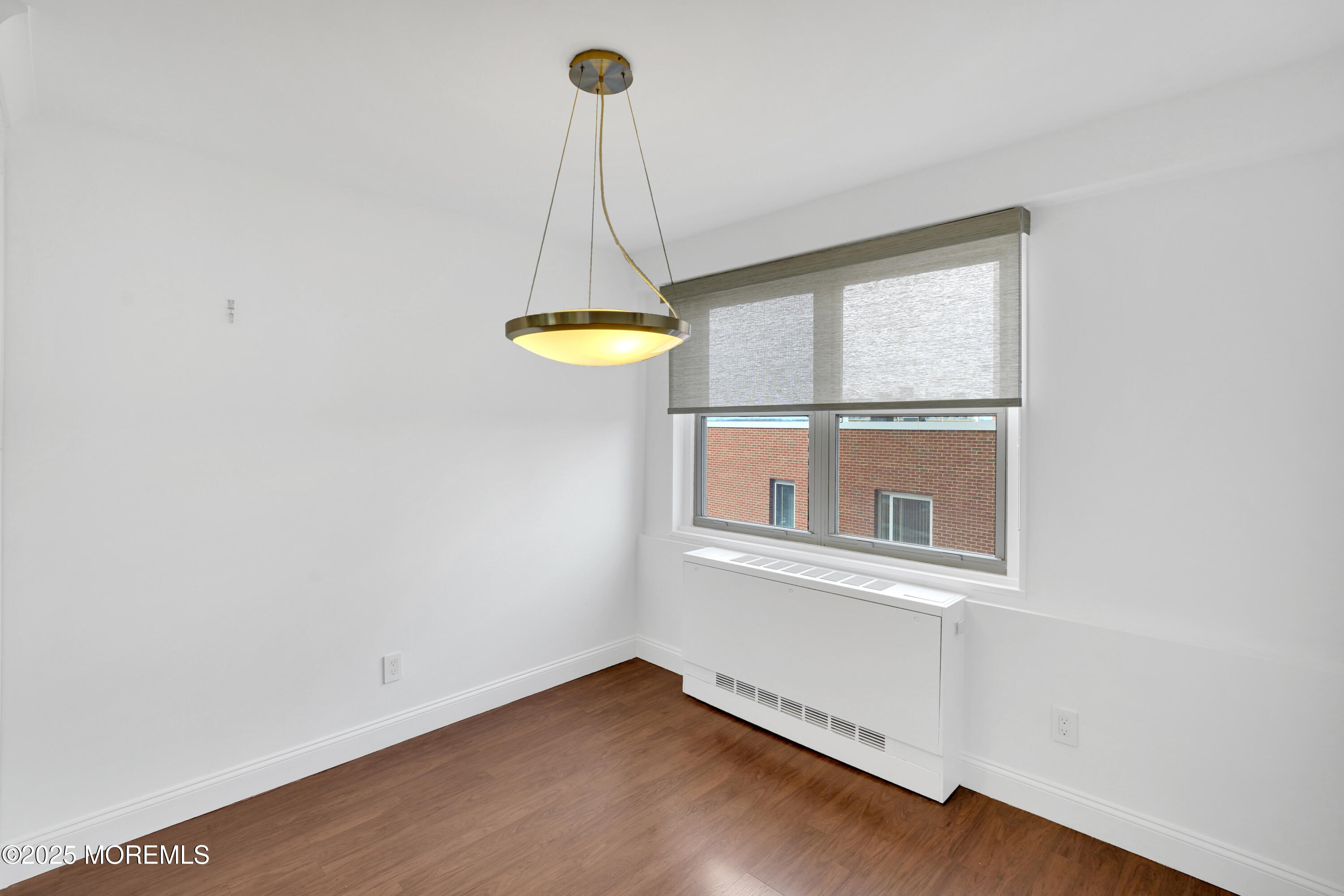 28 Riverside Avenue, Unit 5J Red Bank, NJ 07701 - Photo 14 of 35 a view of a room with a window and wooden floor