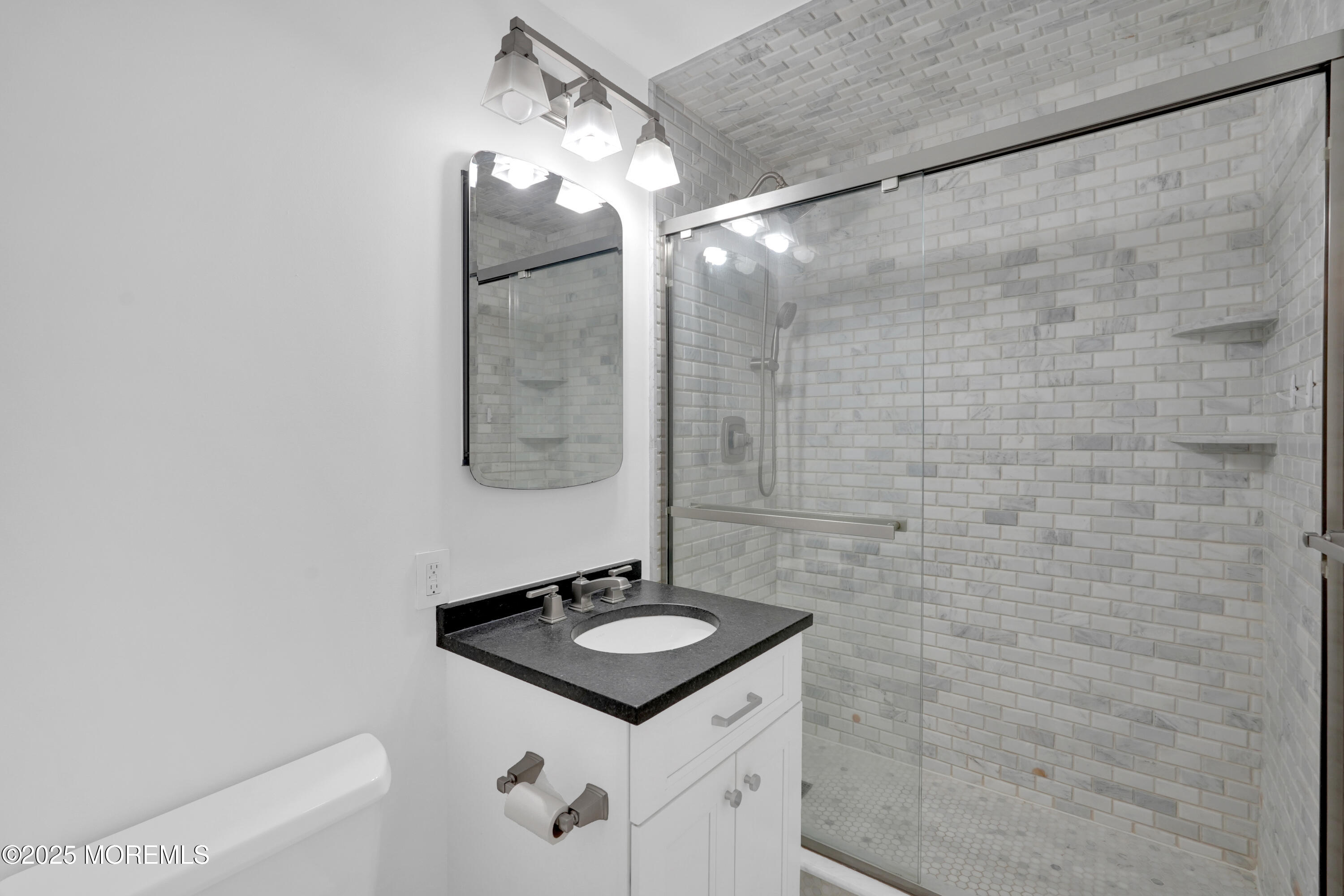 28 Riverside Avenue, Unit 5J Red Bank, NJ 07701 - Photo 15 of 35 a bathroom with a sink a mirror and vanity