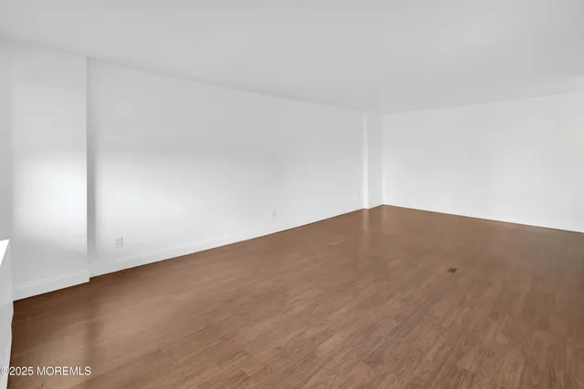 a view of wooden floor and brick wall