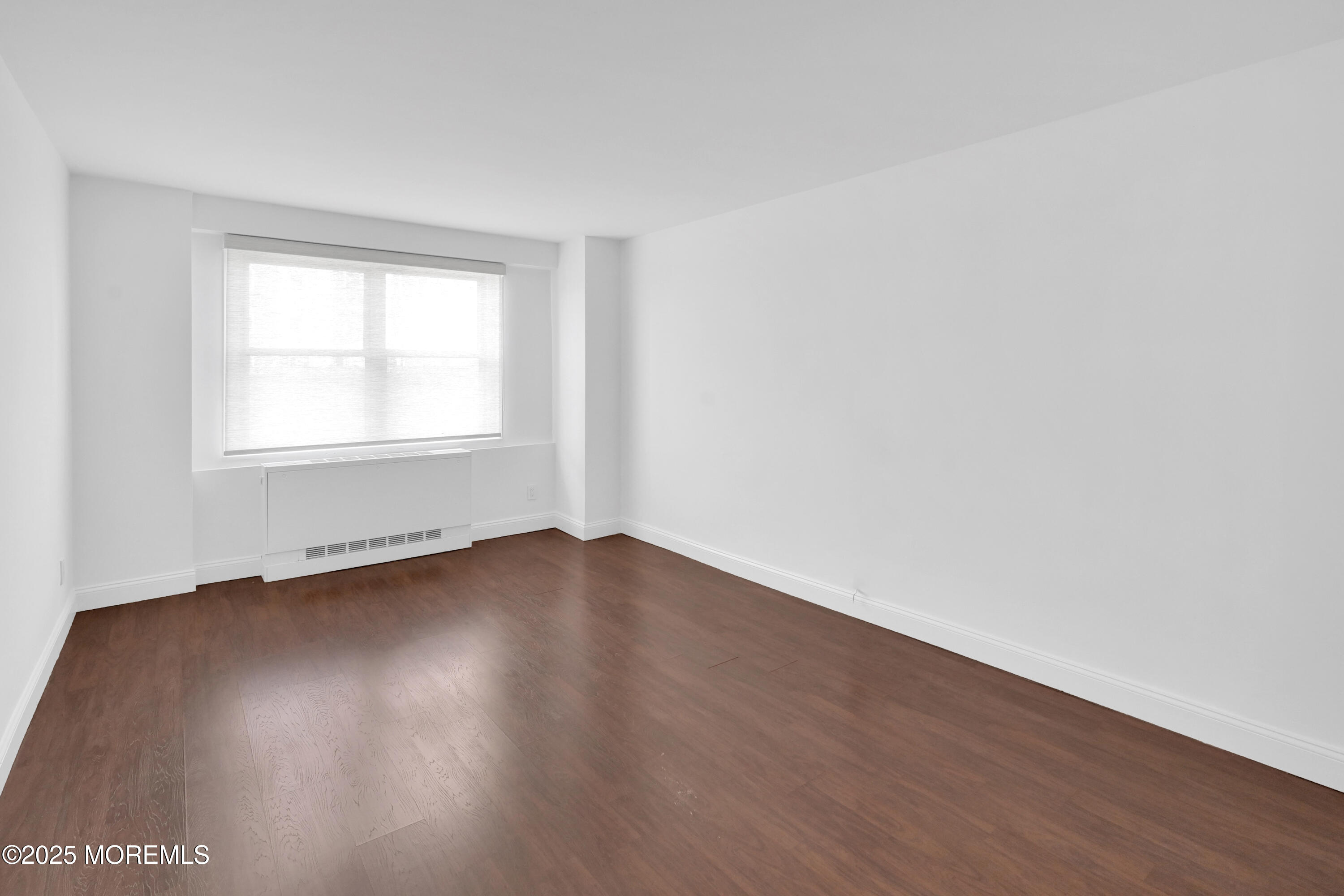 28 Riverside Avenue, Unit 5J Red Bank, NJ 07701 - Photo 20 of 35 an empty room with wooden floor and windows