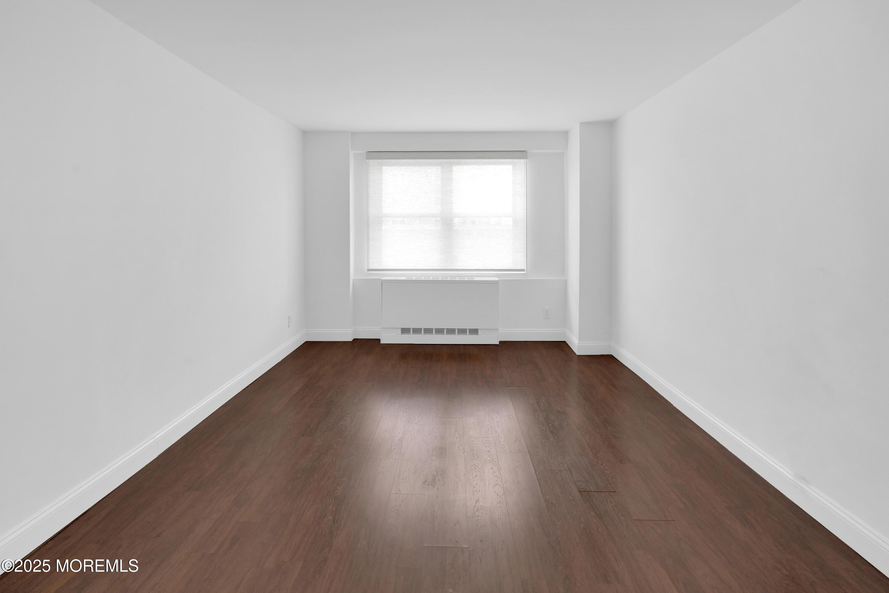 28 Riverside Avenue, Unit 5J Red Bank, NJ 07701 - Photo 21 of 35 an empty room with wooden floor and windows