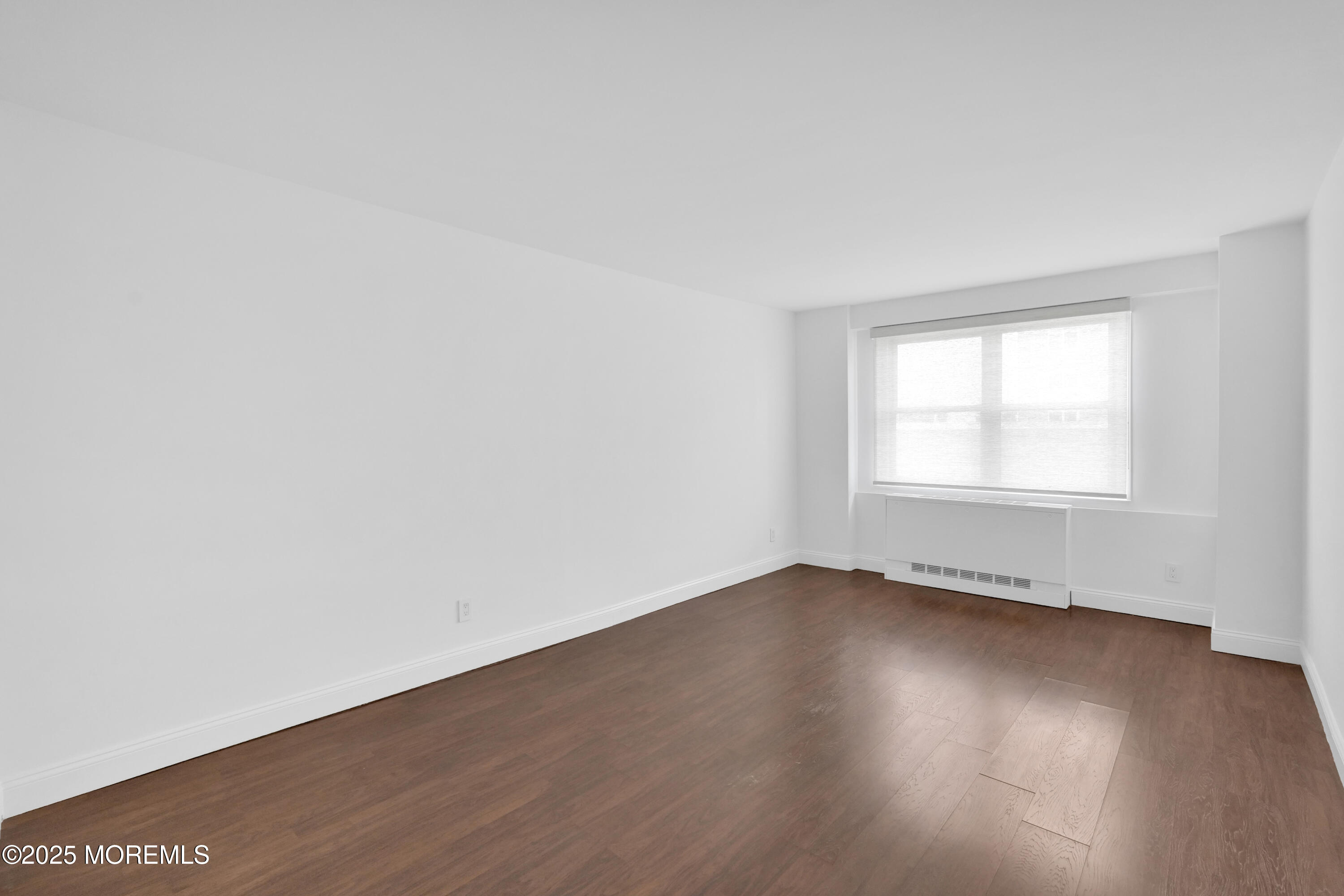 28 Riverside Avenue, Unit 5J Red Bank, NJ 07701 - Photo 22 of 35 an empty room with wooden floor and windows