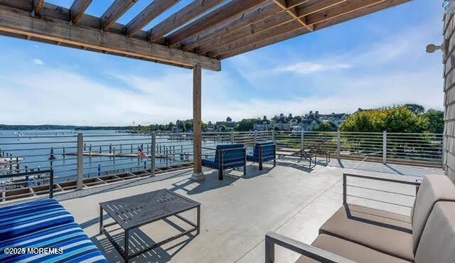 28 Riverside Avenue, Unit 5J Red Bank, NJ 07701 - Photo 26 of 35 a view of a roof deck with couches and wooden floor