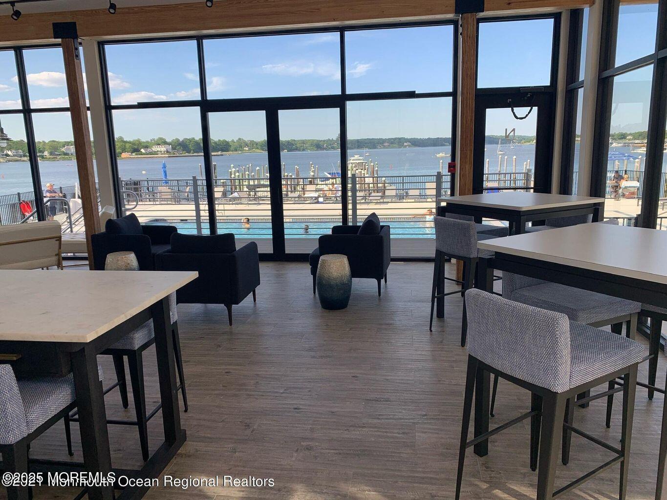 28 Riverside Avenue, Unit 5J Red Bank, NJ 07701 - Photo 31 of 35 a view of a dining room with furniture large windows and wooden floor