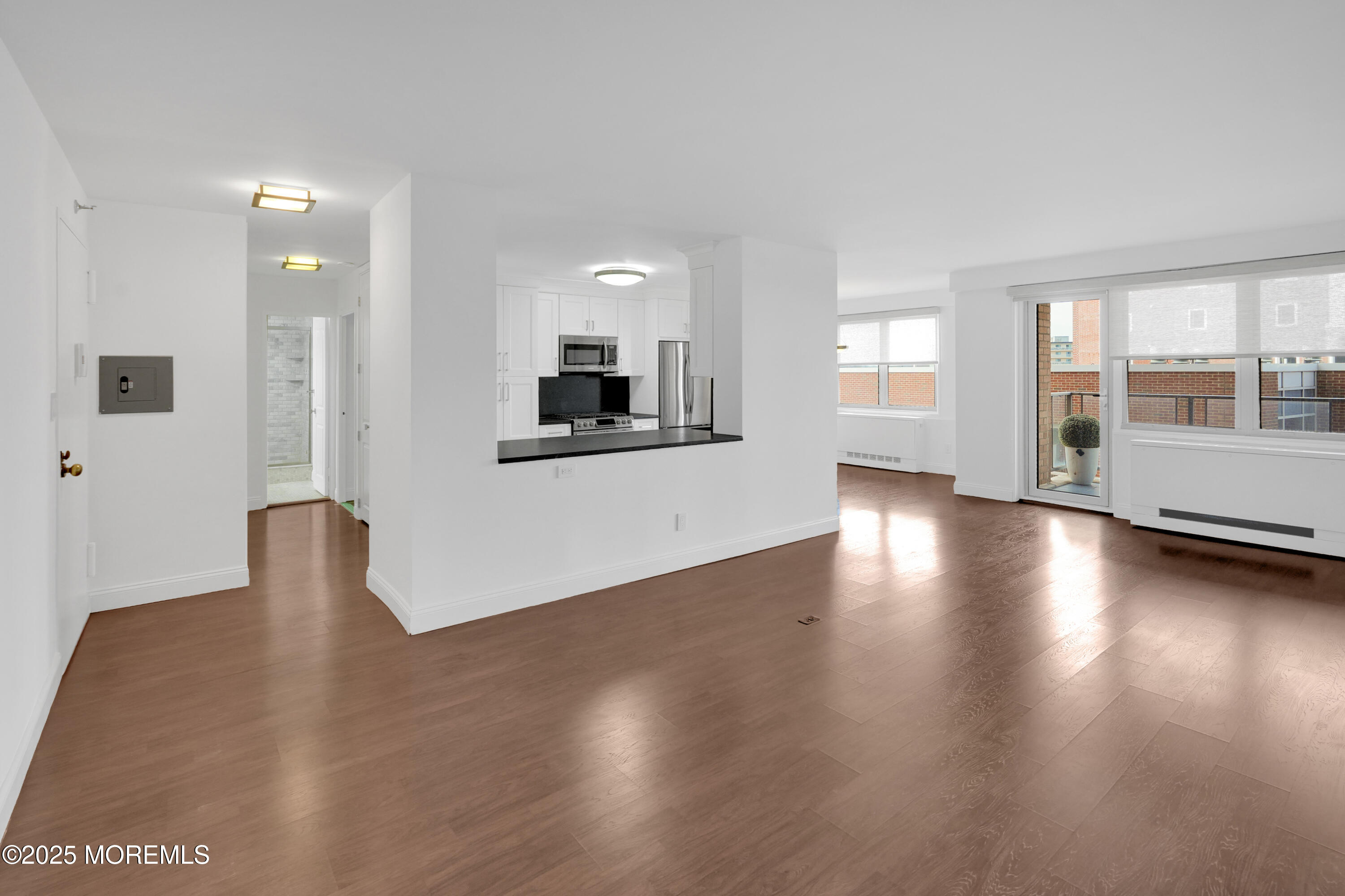 28 Riverside Avenue, Unit 5J Red Bank, NJ 07701 - Photo 5 of 35 a view of a kitchen with a stove wooden floor and a window
