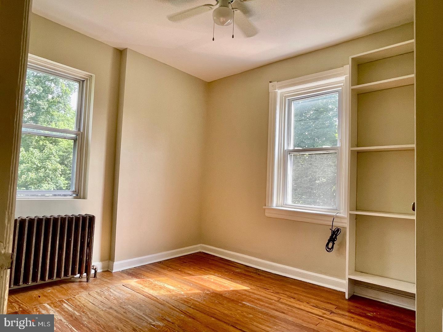 692 Lenni Road Aston, PA 19014 - Photo 17 of 28 a view of an empty room with wooden floor and a window