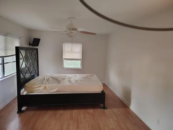 a bed sitting in a bedroom next to a window