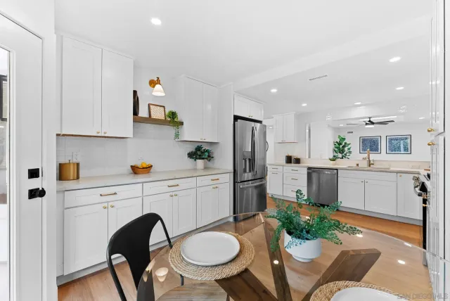 a kitchen with furniture a refrigerator and a stove