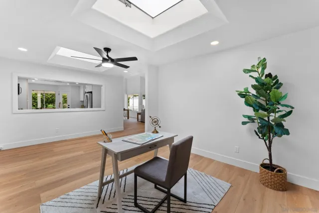 a view of a workspace with furniture and a potted plant