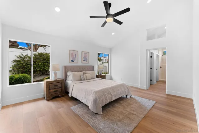 a bedroom with a large bed and a large window