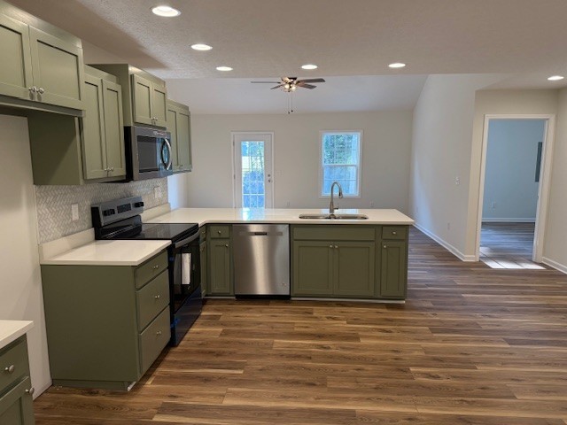 22 Ghea Road Normandy, TN 37360 - Photo 13 of 40 a kitchen with stainless steel appliances granite countertop a sink a stove top oven and wooden floors
