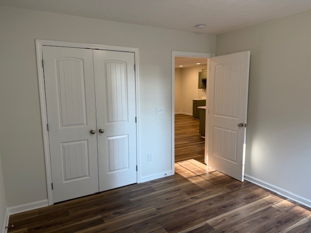 22 Ghea Road Normandy, TN 37360 - Photo 32 of 40 a view of an empty room with wooden floor and a bathroom