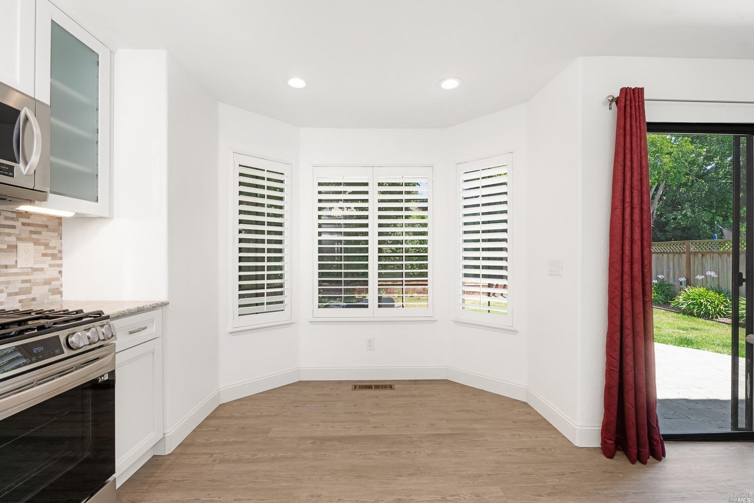 7216 Roxanne Lane Rohnert Park, CA 94928 - Photo 14 of 40 a view of an empty room with a fireplace and a window