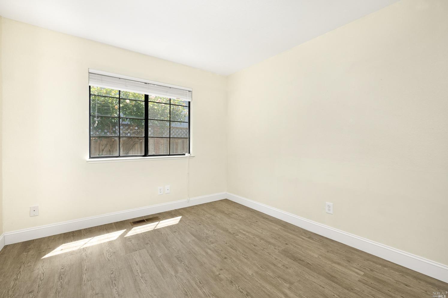 7216 Roxanne Lane Rohnert Park, CA 94928 - Photo 20 of 40 an empty room with wooden floor and windows