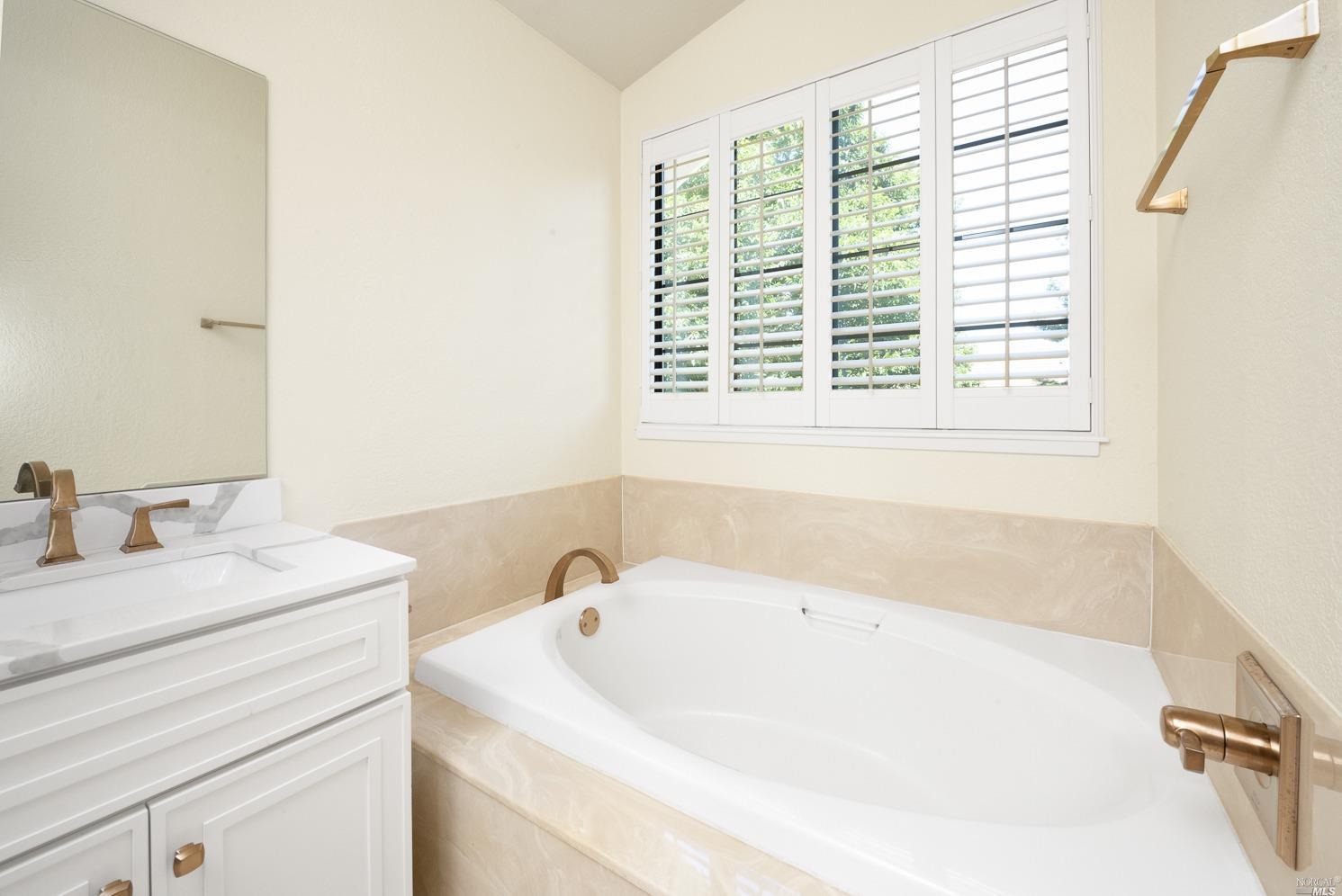 7216 Roxanne Lane Rohnert Park, CA 94928 - Photo 27 of 40 a bathroom with a tub a sink and a window