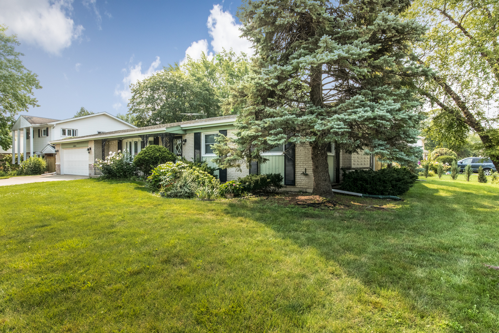 1901 Manor Lane Park Ridge, IL 60068 - Photo 2 of 18 a front view of a house with a garden