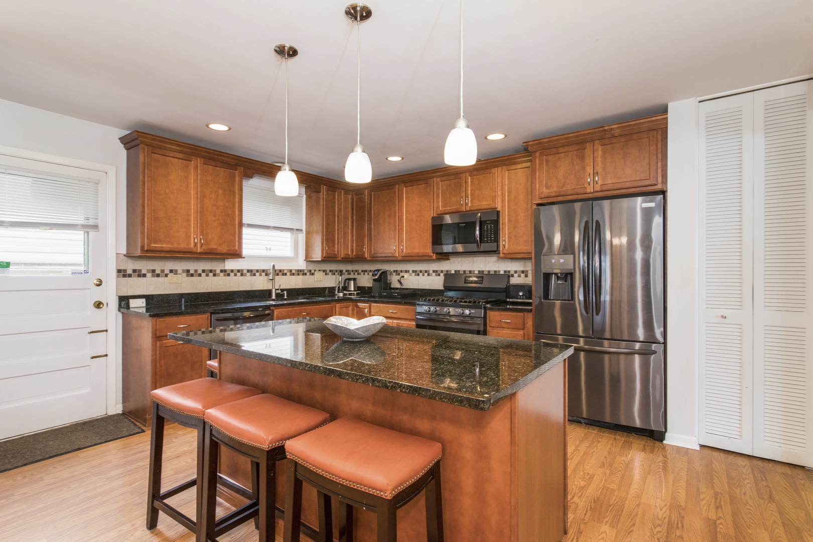 1901 Manor Lane Park Ridge, IL 60068 - Photo 7 of 18 a kitchen with stainless steel appliances granite countertop a refrigerator a stove top oven a sink dishwasher and a refrigerator with wooden floor