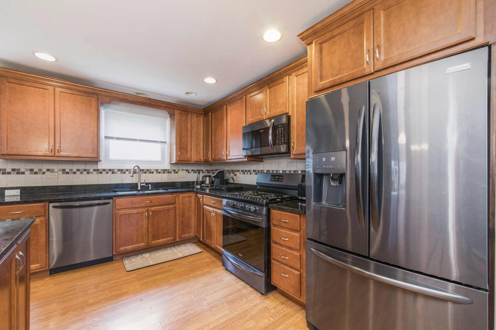 1901 Manor Lane Park Ridge, IL 60068 - Photo 8 of 18 a kitchen with granite countertop stainless steel appliances a refrigerator stove top oven and sink