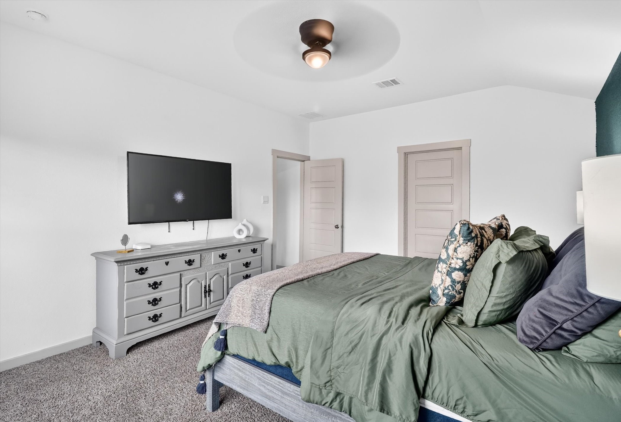 7907 Sleek Flock Lane Rosharon, TX 77583 - Photo 16 of 28 Tucked away from the secondary bedrooms, the primary suite offers a quieter, more private space to unwind while staying conveniently positioned to the main living area.