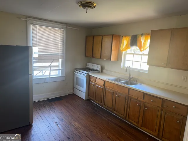 a kitchen with sink window and cabinets