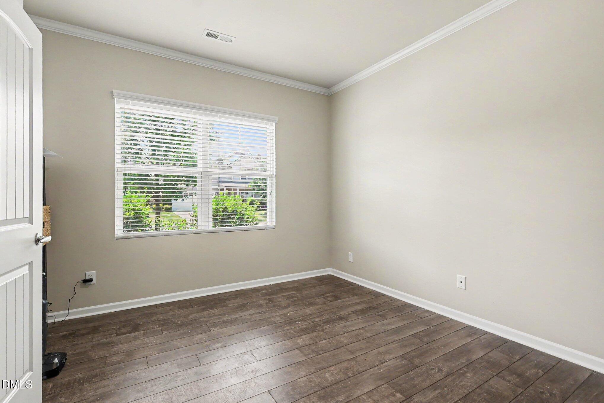 4366 Auburn Hills Drive Raleigh, NC 27616 - Photo 22 of 40 wooden floor in an empty room with a window