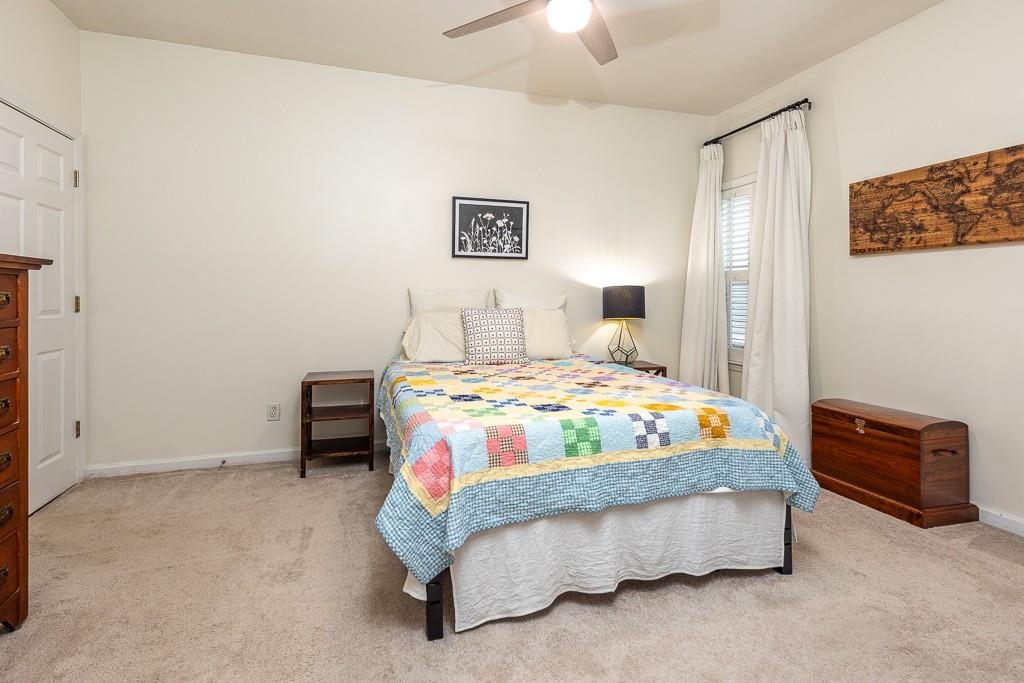 1290 Isle Pointe Drive Memphis, TN 38103 - Photo 16 of 30 a bedroom with a bed and a lamp on a dresser