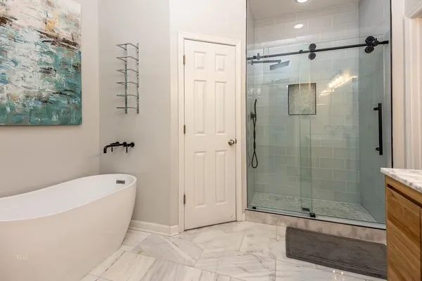a bathroom with a bathtub and a shower