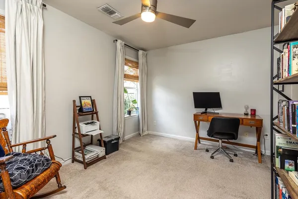 a view of a livingroom with workspace and a window