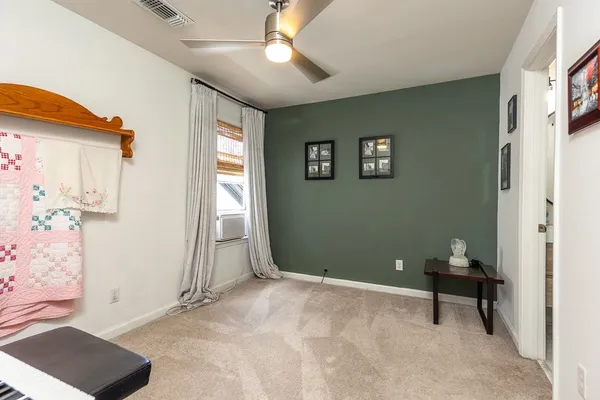 a view of a livingroom with wooden floor and a window
