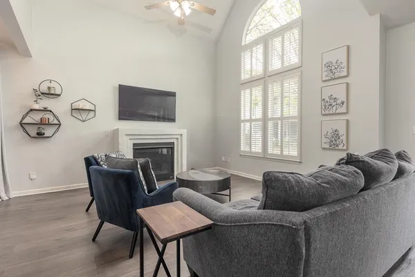 a living room with furniture a fireplace and a window