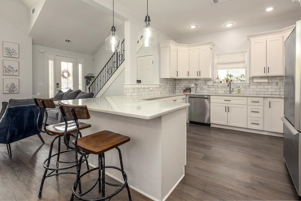 1290 Isle Pointe Drive Memphis, TN 38103 - Photo 8 of 30 a large kitchen with cabinets chairs and wooden floor